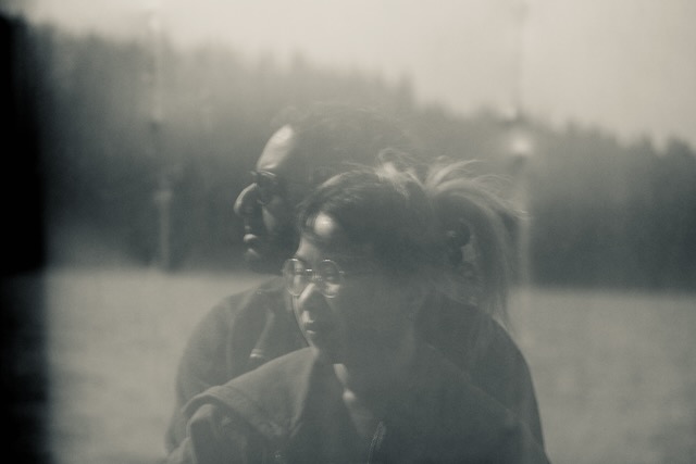 candid - couple through a reflection